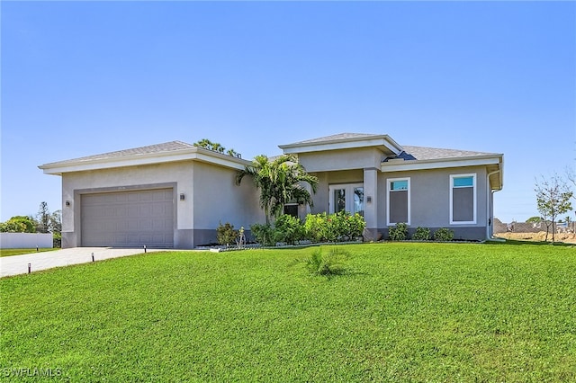 view of front of property with a garage and a front yard