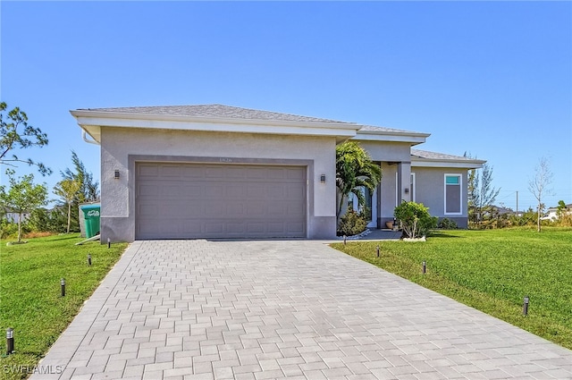 view of front of property with a garage and a front lawn