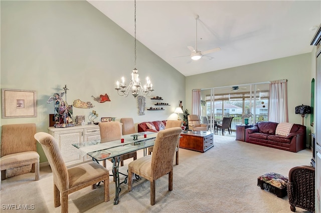 carpeted dining room featuring ceiling fan with notable chandelier and high vaulted ceiling