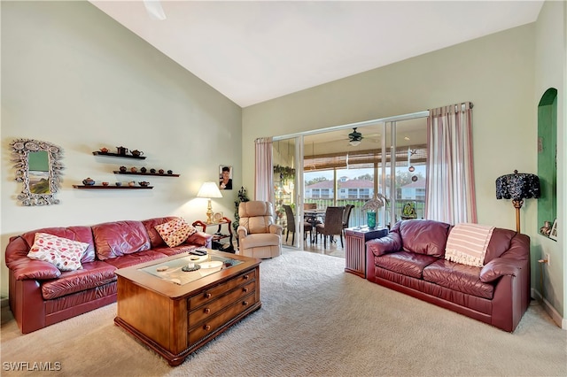 carpeted living room featuring lofted ceiling