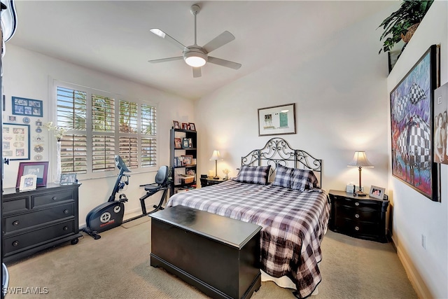 carpeted bedroom with vaulted ceiling and ceiling fan