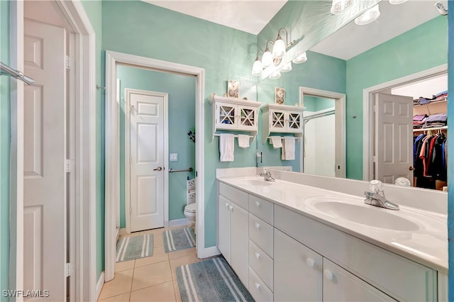 bathroom with tile patterned flooring, vanity, and toilet