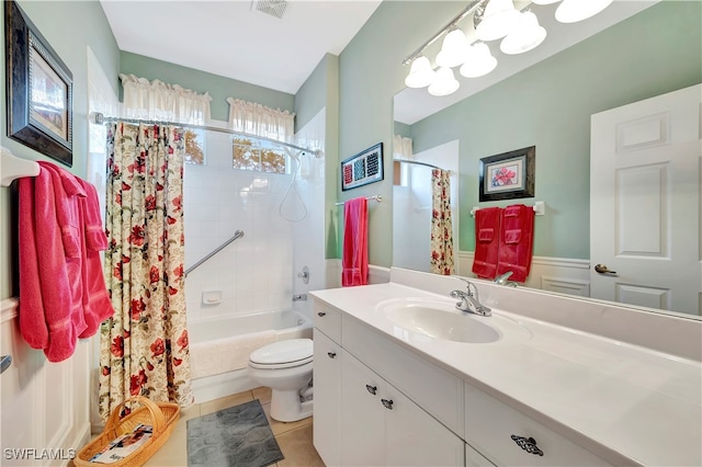 full bathroom featuring tile patterned flooring, vanity, toilet, and shower / bath combo with shower curtain