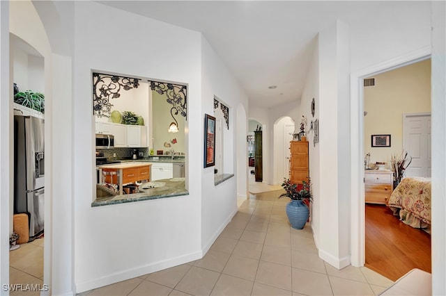 corridor with light hardwood / wood-style floors