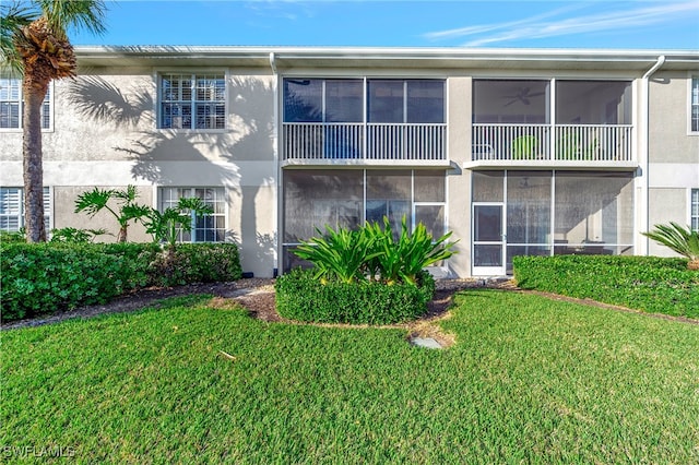 rear view of property with a yard