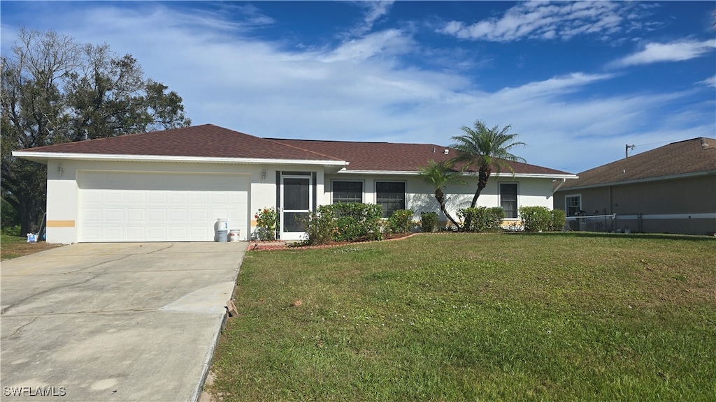 single story home with a garage and a front lawn