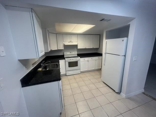 kitchen with white cabinetry, white appliances, sink, and light tile patterned floors