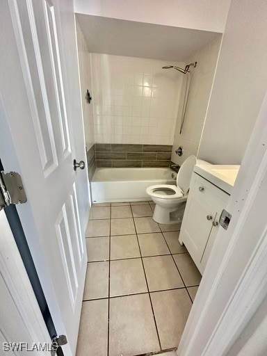 full bathroom featuring tile patterned floors, vanity, toilet, and tiled shower / bath combo