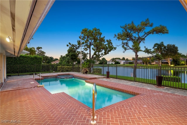 view of pool with a patio area and a water view