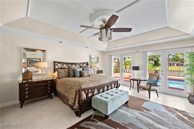 bedroom featuring ceiling fan, access to exterior, a tray ceiling, and french doors