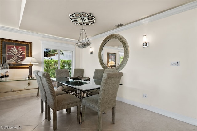 dining space with light tile patterned floors and ornamental molding