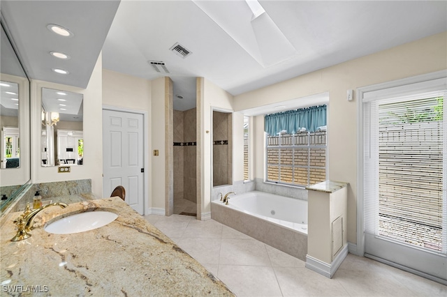 bathroom featuring vanity, tile patterned floors, and plus walk in shower