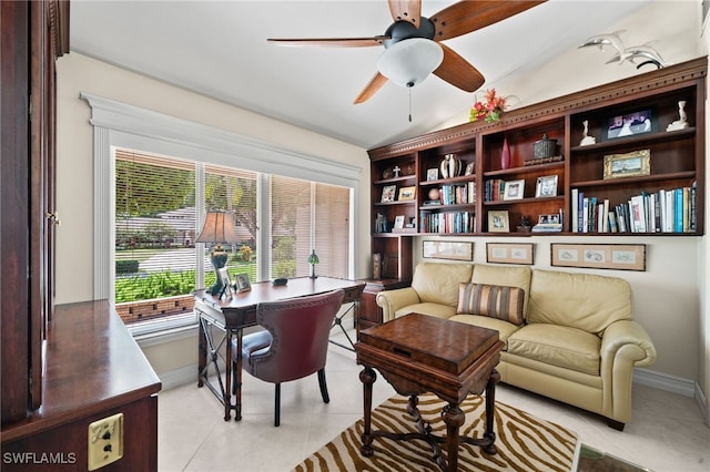 living area with ceiling fan, light tile patterned floors, and lofted ceiling