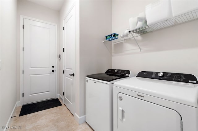 clothes washing area featuring washer and clothes dryer