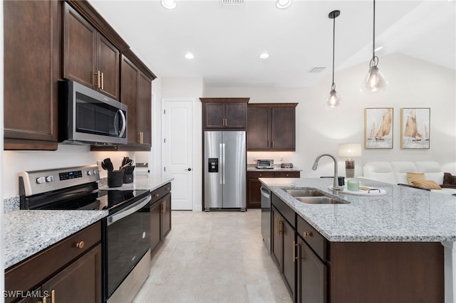 kitchen with pendant lighting, sink, vaulted ceiling, dark brown cabinetry, and stainless steel appliances