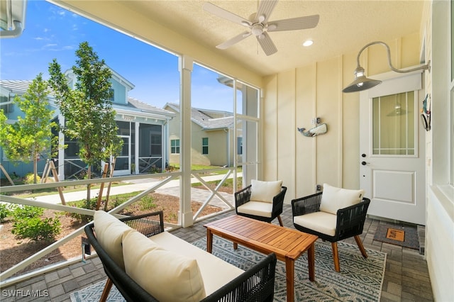 sunroom featuring ceiling fan