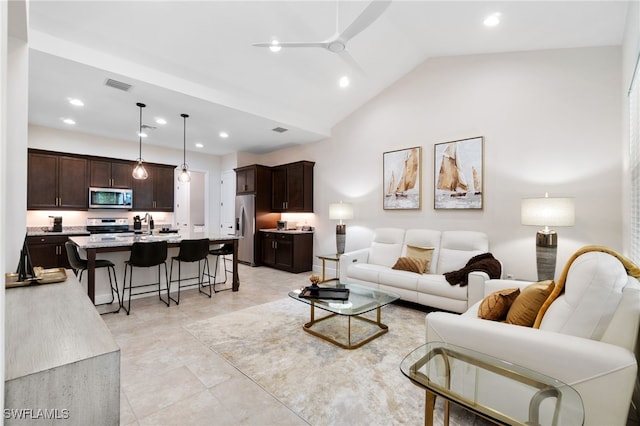 living room featuring ceiling fan, light tile patterned floors, and high vaulted ceiling