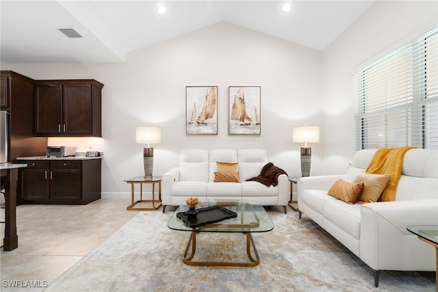 living room featuring light tile patterned floors and lofted ceiling