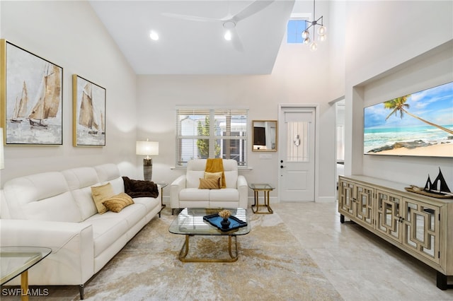 living room featuring high vaulted ceiling and an inviting chandelier