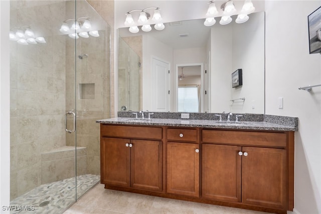 bathroom featuring tile patterned flooring, vanity, and an enclosed shower