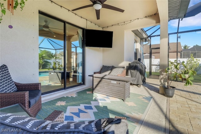 view of patio / terrace featuring glass enclosure, ceiling fan, and grilling area