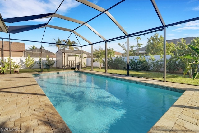 view of pool featuring glass enclosure and a shed