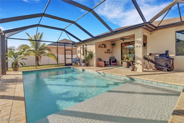 view of pool with a lanai, ceiling fan, and a patio area