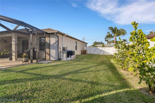 view of yard with a lanai and central AC