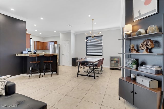 tiled dining area with a chandelier and ornamental molding