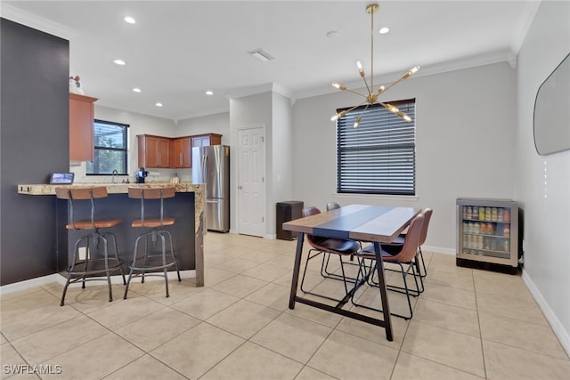 dining area with ornamental molding, heating unit, sink, light tile patterned floors, and a chandelier