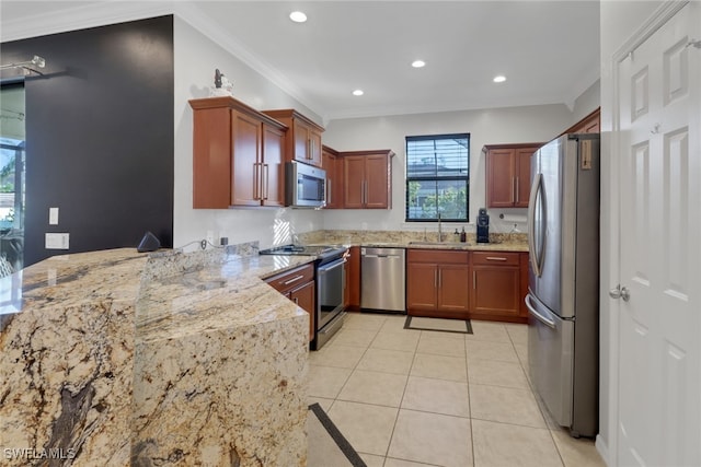 kitchen with kitchen peninsula, appliances with stainless steel finishes, light stone counters, ornamental molding, and sink