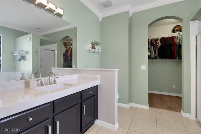 bathroom featuring crown molding, tile patterned flooring, vanity, and an enclosed shower