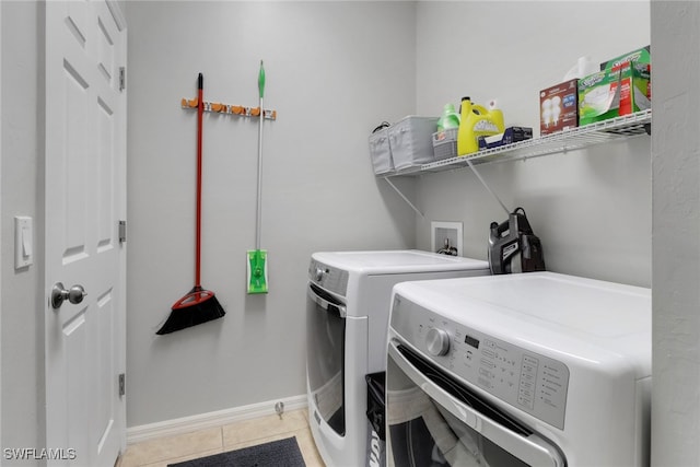 laundry area with light tile patterned floors and independent washer and dryer