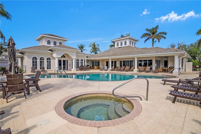 view of pool featuring a patio and a hot tub