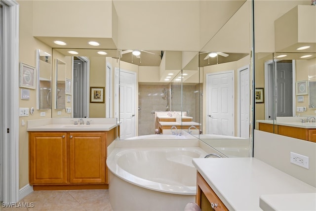 bathroom with tile patterned floors, vanity, a bathtub, and ceiling fan