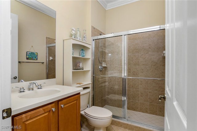 bathroom featuring vanity, toilet, ornamental molding, and a shower with shower door