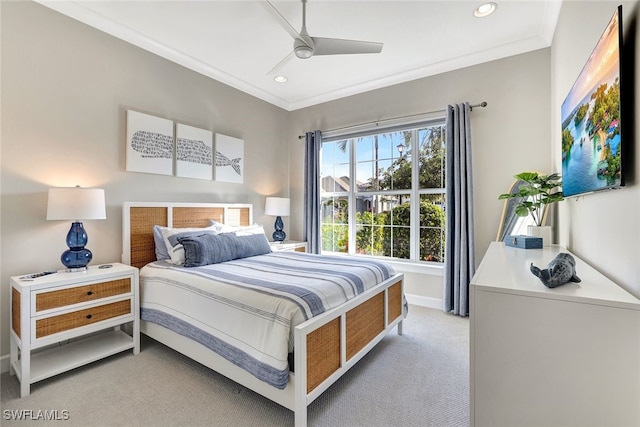 carpeted bedroom featuring ceiling fan and ornamental molding