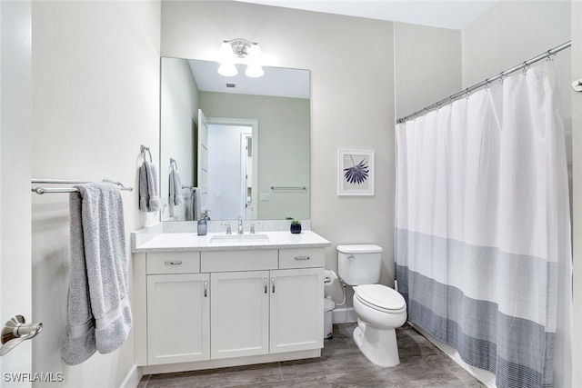 bathroom with vanity, toilet, and curtained shower