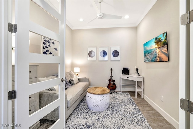 interior space with hardwood / wood-style flooring, ceiling fan, and ornamental molding