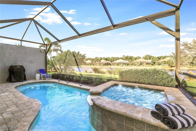 view of swimming pool featuring area for grilling, a lanai, and an in ground hot tub