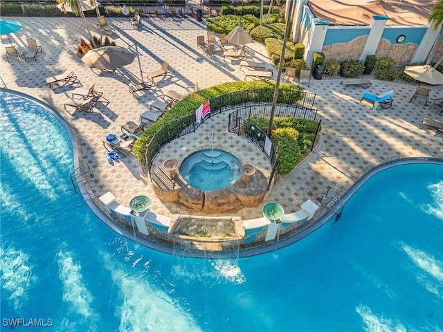 pool with fence and a patio