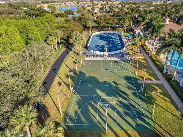 view of sport court with a water view and community basketball court