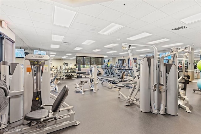 exercise room with a drop ceiling and visible vents