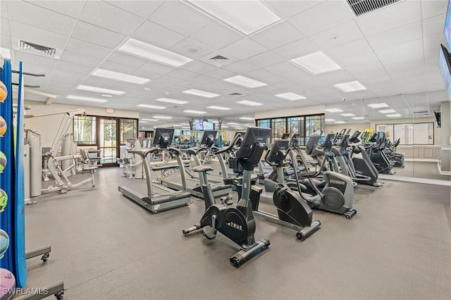 gym featuring a paneled ceiling and visible vents