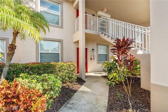 entrance to property featuring stucco siding