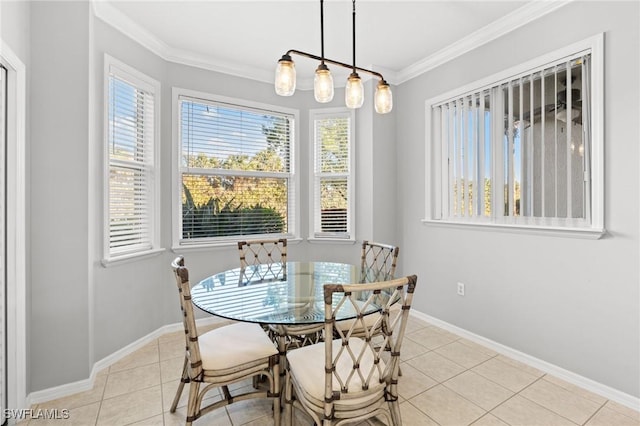 dining room with light tile patterned floors, ornamental molding, and baseboards