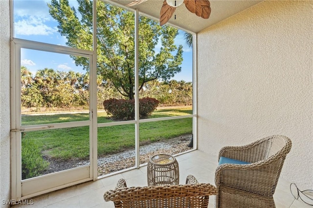 sunroom with ceiling fan and a wealth of natural light