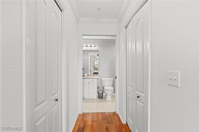 hallway with dark wood-type flooring and crown molding