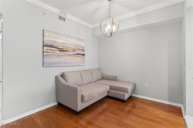 living area featuring ornamental molding, wood finished floors, visible vents, and baseboards