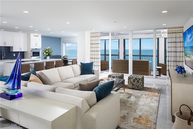 living room with ceiling fan and sink